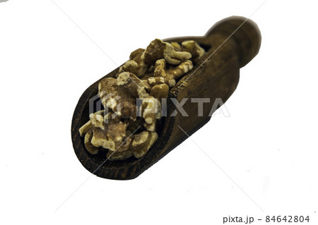 Walnuts kernels on wooden spoon isolated on white background. 84642804