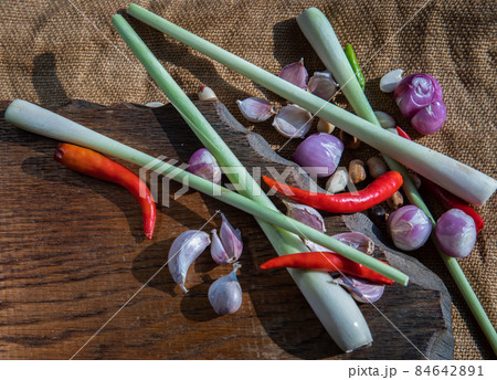 Herbs and ingredient mixed (Lemon Grass, Shallot, Garlic, Chili) on wooden chopping board. Herbs and ingredient mixed (Lemon Grass, Shallot, Garlic, Chili) on wooden chopping board. 84642891