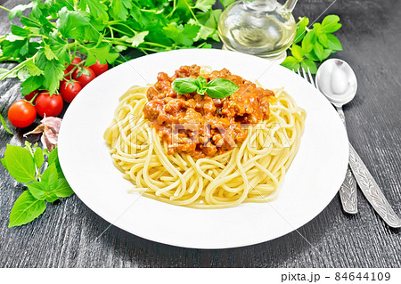 Spaghetti with bolognese on dark wooden board Spaghetti with bolognese on dark wooden board 84644109