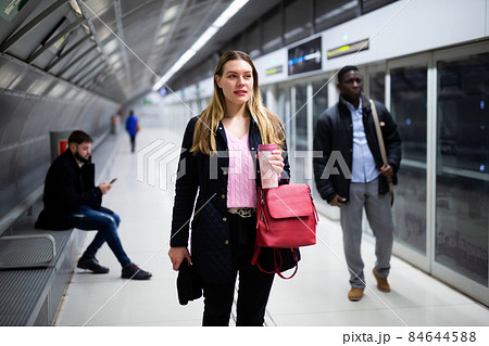 Young woman waiting for train in underground station Young woman waiting for train in underground station 84644588