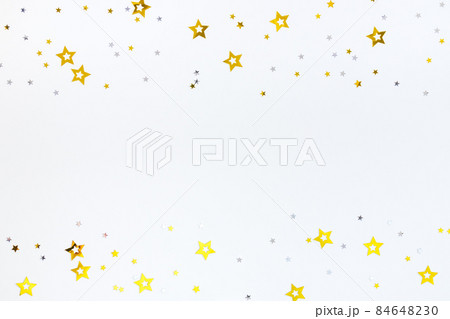 Confetti of shining gold and silver stars on a white background. Festive concept. Frame, flat lay, copy space. 84648230