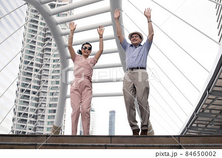 Happy success senior Asian couples are glad and jumping on a trip together. Happy success senior Asian couples are glad and jumping on a trip together. 84650002