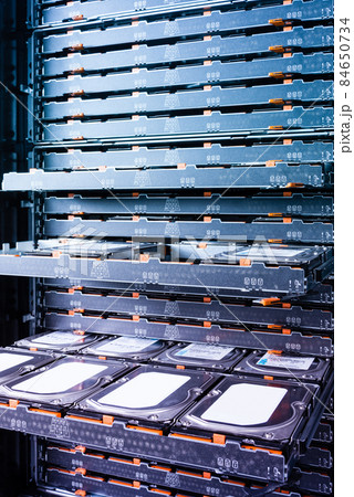 Cluster of hard drives inside open tray 84650734