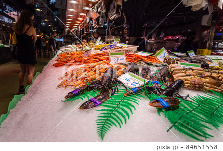 Barcelona, Spain - September 23, 2021: Inside the Mercat de la Boqueria or simply La Boqueria, large public market at La Rambla, Barcelona. Fishmonger and seafood stalls with big variety of fresh fish 84651558
