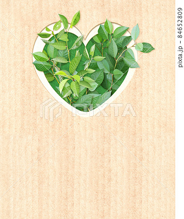Heart shape hole and green leaves on cardboard texture. Ecology concept Heart shape hole and green leaves on cardboard texture. Ecology concept 84652809