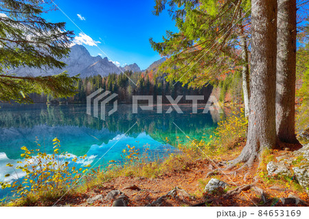Fairytale  view of Fusine lake with Mangart peak on background 84653169
