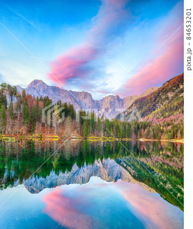 Breathtaking view of sunset over Fusine lake with Mangart peak on background. Breathtaking view of sunset over Fusine lake with Mangart peak on background. 84653201