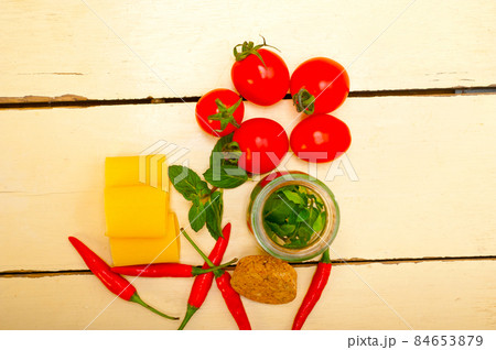Italian pasta paccheri with tomato mint and chili pepper 84653879