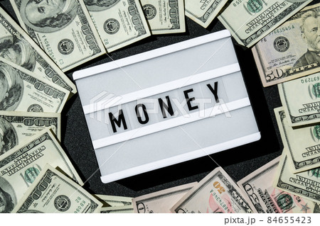 Lightbox board with the word MONEY in black letters around Us dollar banknotes. Finance background. Business, financial success and making money concept. Business budget of wealth and prosperity Lightbox board with the word MONEY in black letters around Us dollar banknotes. Finance background. Business, financial success and making money concept. Business budget of wealth and prosperity 84655423
