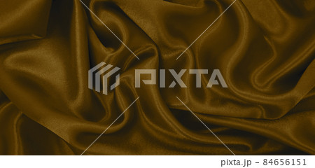 Smooth elegant brown silk or satin luxury cloth texture as abstract background. Luxurious background design wallpaper. In Sepia toned. Retro style Smooth elegant brown silk or satin luxury cloth texture as abstract background. Luxurious background design wallpaper. In Sepia toned. Retro style 84656151