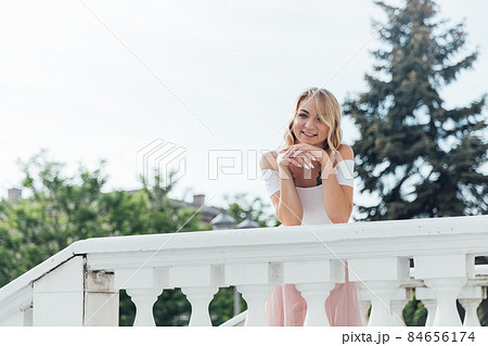 beautiful blonde woman dancing to music outside beautiful blonde woman dancing to music outside 84656174