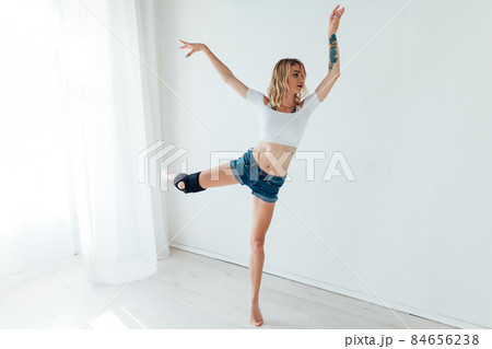 athletic woman blonde dancing to music alone 84656238