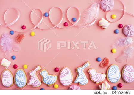 Homemade Easter cookies on pink background flat top view 84658667
