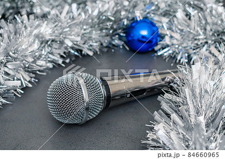 Microphone and decorations on a Christmas tree for a party 84660965