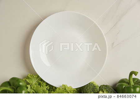 vegetable concept some green vegetables arranged at the bottom of white background vegetable concept some green vegetables arranged at the bottom of white background 84663074
