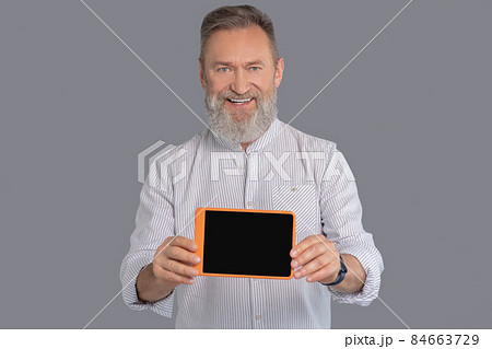 A man holding a tablet in hands 84663729