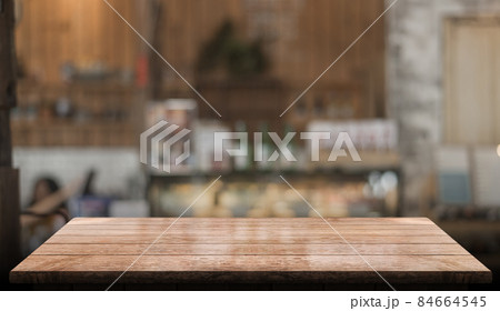 Empty wooden table top with lights bokeh on blur restaurant background. 84664545