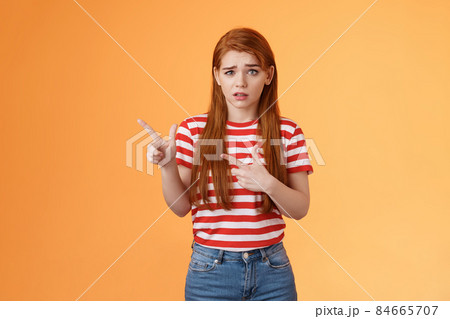 Insecure questioned frustrated cute redhead girl feel nervous unsure about suspicious offer frowning, grimacing doubtful and hesitant, pointing left look camera puzzled, asking question Insecure questioned frustrated cute redhead girl feel nervous unsure about suspicious offer frowning, grimacing doubtful and hesitant, pointing left look camera puzzled, asking question 84665707