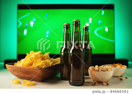 Beer and snacks set on football match tv background. Beer and snacks set on football match tv background. 84666561
