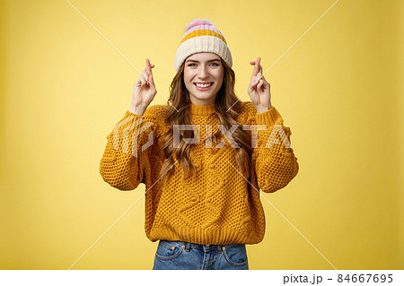 Optimistic lucky cute young stylish female university student praying god help pass exams cross fingers good fortune smiling broadly faithfully hope receive good news, make wish yellow background Optimistic lucky cute young stylish female university student praying god help pass exams cross fingers good fortune smiling broadly faithfully hope receive good news, make wish yellow background 84667695