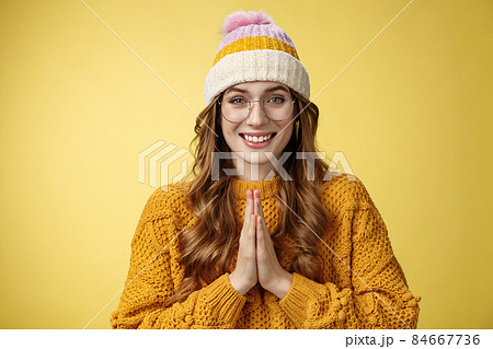 Thanks lot. Portrait charming tender cute european young woman thankfully looking camera bowing polite show namaste appreciation gesture press palms together smiling yellow background 84667736