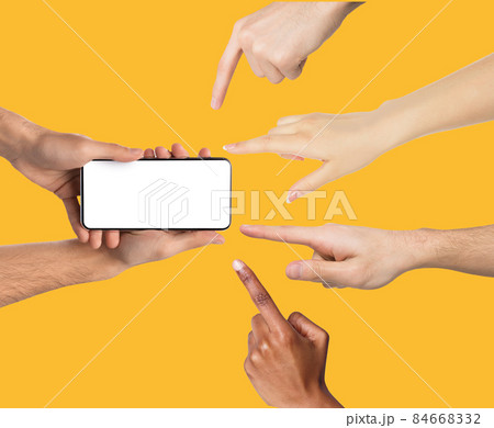 Male hands holding smartphone, people pointing at screen Male hands holding smartphone, people pointing at screen 84668332