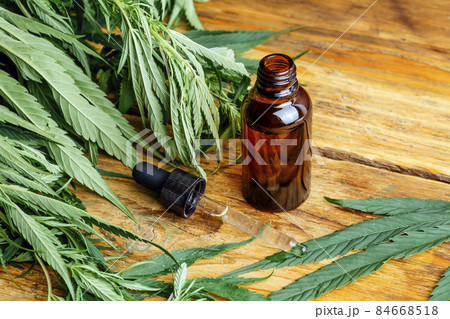 Cannabis oil cannabidiol cbd. Medical cannabis marijuana and extract on wooden background. Cannabis oil cannabidiol cbd. Medical cannabis marijuana and extract on wooden background. 84668518