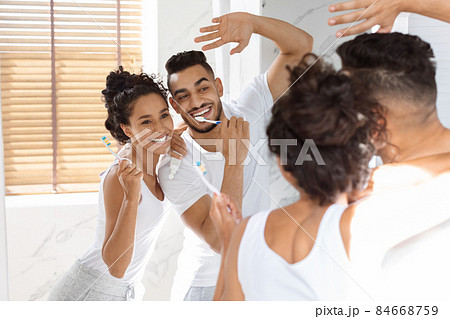 Morning Hygiene. Joyful Middle Eastern Couple Brushing Teeth And Dancing In Bathroom Morning Hygiene. Joyful Middle Eastern Couple Brushing Teeth And Dancing In Bathroom 84668759