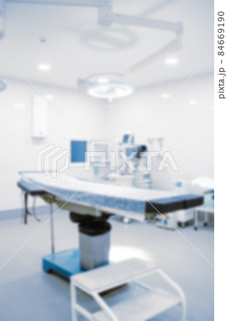 Blurry empty interior operating room and modern equipment in hospital.Medical device for surgeon surgical emergency patient in blue tone style.Save life medical treatment concept. Blurry empty interior operating room and modern equipment in hospital.Medical device for surgeon surgical emergency patient in blue tone style.Save life medical treatment concept. 84669190