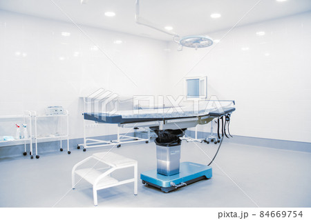 Empty operating room in a hospital. Surgical equipment with operating table. Medical device for emergency patient in blue tone style. Blank Emergency Surgery Room. Clinic interior for background. 84669754