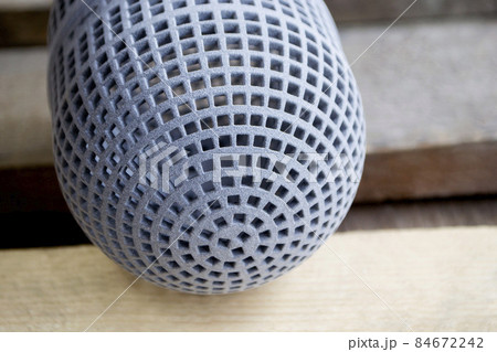 Gray object printed on powder industrial 3D printer. Three-dimensional volumetric model created from powder plastic close-up. 84672242