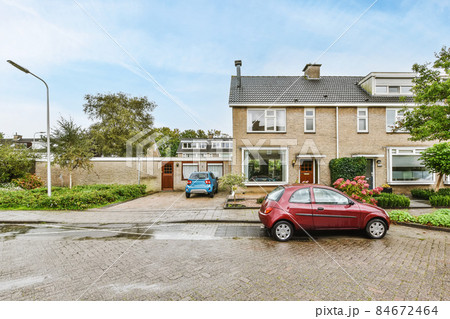 View of the facade of a two-story brick house 84672464