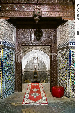Ornate carved wood and brass entrance of a restaurant with tile steps in the medina of Marrakech, Morocco Ornate carved wood and brass entrance of a restaurant with tile steps in the medina of Marrakech, Morocco 84672579