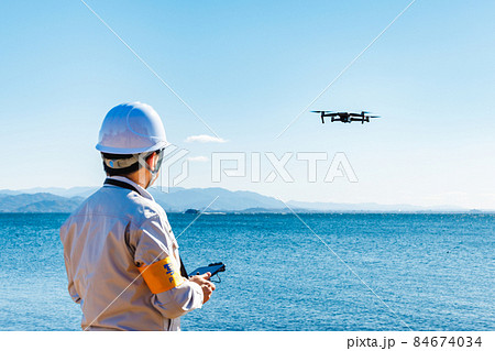ドローンを操縦する作業員 ドローンを操縦する作業員 84674034