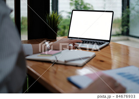 business woman sitting in office with laptop computer on desk business woman sitting in office with laptop computer on desk 84676933