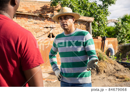 Afro and latino males talking on farm 84679068
