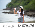 Happy traveler and tourism young women travel summer on the beach.  84679176