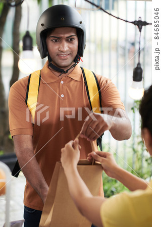 Courier on Scooter Receiving Paper Bag Courier on Scooter Receiving Paper Bag 84685046