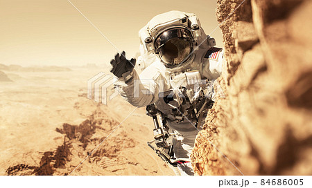 Astronaut Martian is on a mission to the red planet and climbs up a mountain on a rock. Space man conquers and populates the new planet Mars. Planet Mars and people, concept. Welcome to new home Astronaut Martian is on a mission to the red planet and climbs up a mountain on a rock. Space man conquers and populates the new planet Mars. Planet Mars and people, concept. Welcome to new home 84686005