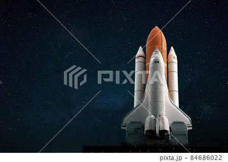 The new spacecraft shuttle prepares to take off against the backdrop of a blue starry sky. Space mission concept. Rocket flies into space 84686022