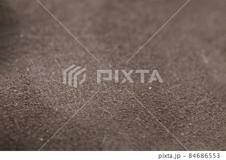 Close-up photograph of brown suede surface, texture 84686553