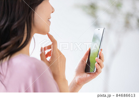 部屋着を着てスマホを操作する女性 84686613