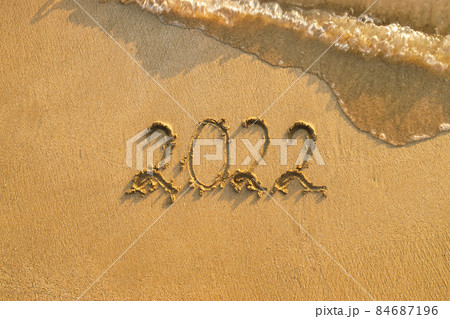 top view of 2022 written in the sand beach 84687196
