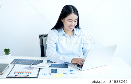 Asian female accountant sits at their desks and calculates financial graphs showing results about their investments, plan a successful business growth process 84688242
