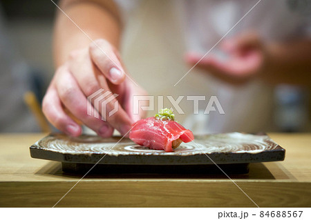 Tuna Sushi with fresh wasabi served on ceramic plate. Enjoy Omakase experience at Japanese Sushi Restaurant. Tuna Sushi with fresh wasabi served on ceramic plate. Enjoy Omakase experience at Japanese Sushi Restaurant. 84688567