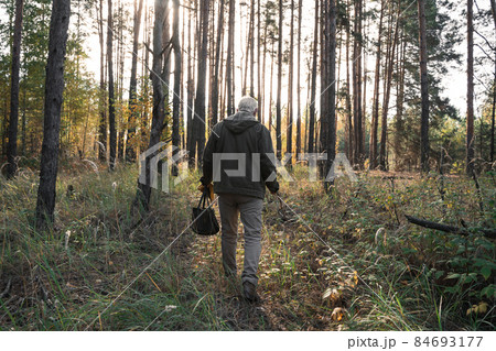 Man looking at the nature while being at the forest alone and relaxing 84693177