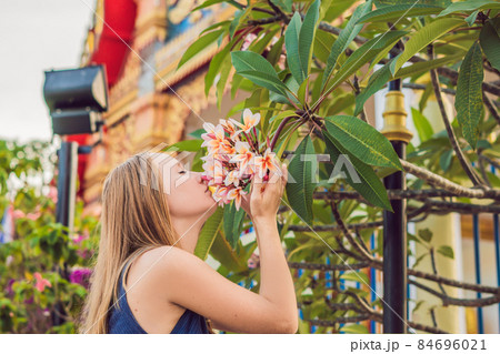 Young woman tourist in Thai temple in Phuket Town Wat Mongkolnimit Young woman tourist in Thai temple in Phuket Town Wat Mongkolnimit 84696021