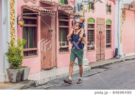 Dad and son are tourists on the Street in the Portugese style Romani in Phuket Town. Also called Chinatown or the old town 84696490