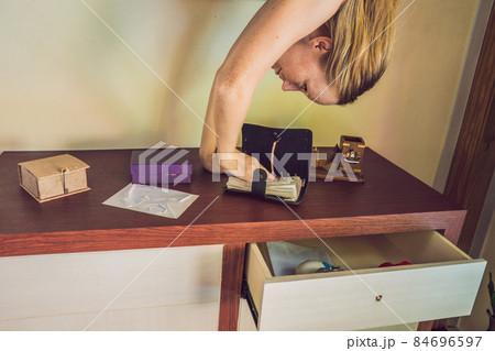 A woman is standing on his hands upside down in the living room A woman is standing on his hands upside down in the living room 84696597