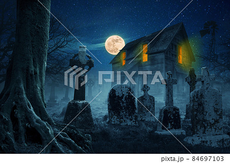 Scary house in the forest near the cemetery at night with a full moon and stars. Halloween idea concept 84697103